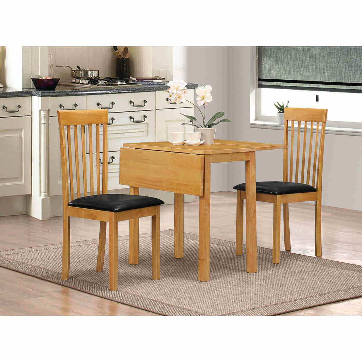 Alt Tag: Cortina Dropleaf Dining Table + 2 Chairs - Oak solid rubberwood drop-leaf table with 2 oak chairs and black PU seat pads