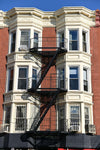 HMO Key Requirements and Considerations - multi-occupancy building exterior with fire escape stairs for safety compliance