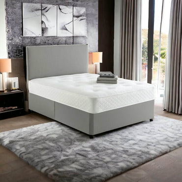 Drift Orthopaedic Mattress on grey upholstered bed frame with white stretch fabric cover in modern bedroom
