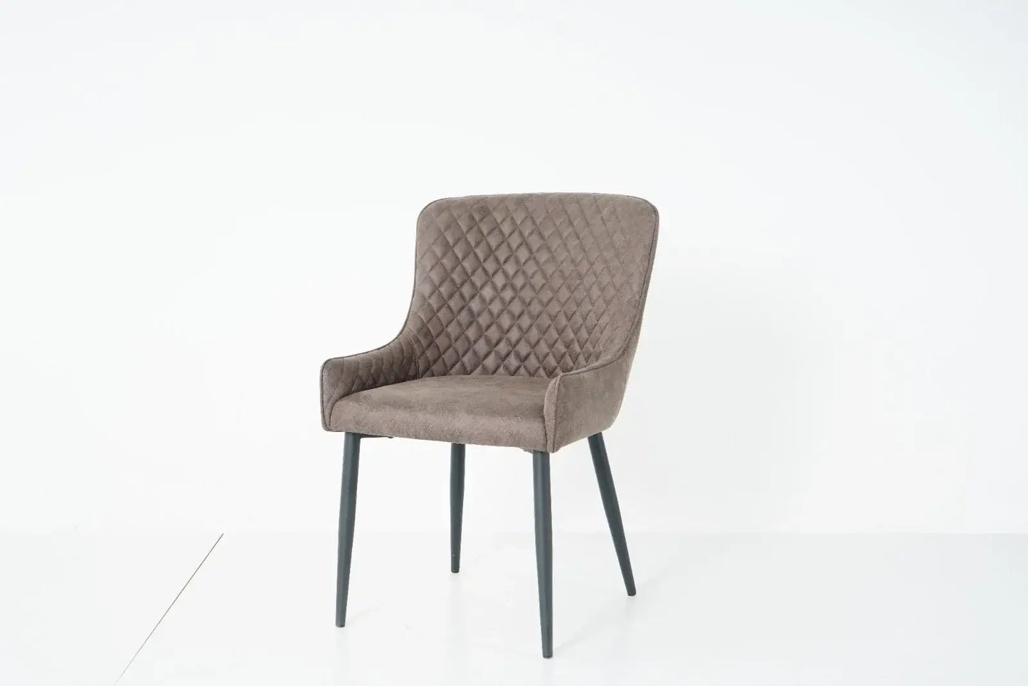 Alt Tag: Suede Oxford Fabric Dining Chairs in grey faux suede with quilted back, padded armchair-style seat and black tapered legs