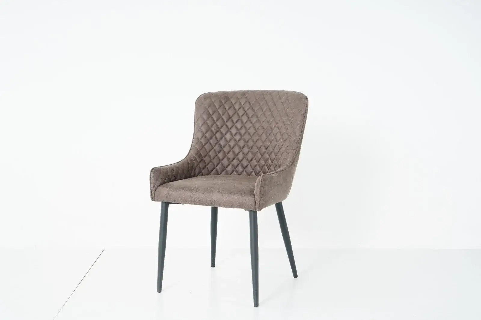 Alt Tag: Suede Oxford Fabric Dining Chairs in grey faux suede with quilted back, padded armchair-style seat and black tapered legs