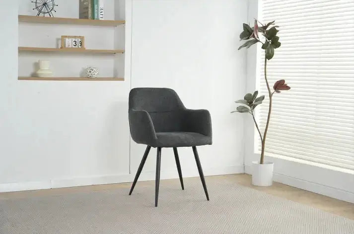 Alt Tag: Ruby Dining Chairs - Upholstered charcoal fabric dining chair with curved backrest and black legs in modern room setting